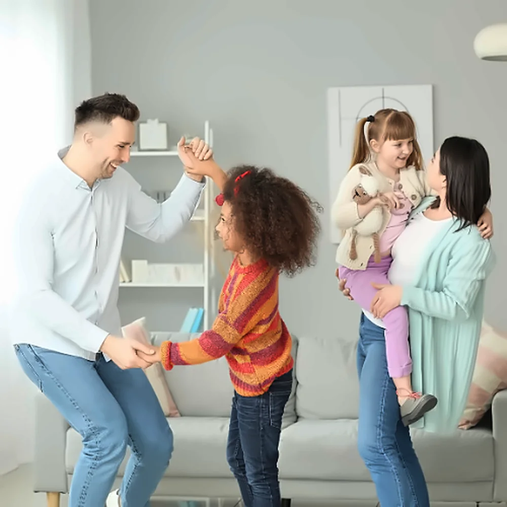 A family dancing together in their living room